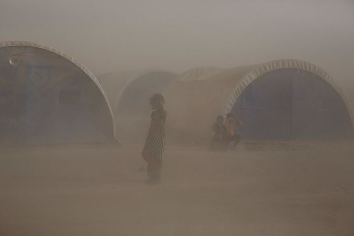 A dust storm engulfs a camp for displaced people in the village of Tinah some 70km south of Mosul, Iraq, on October 14, 2016.