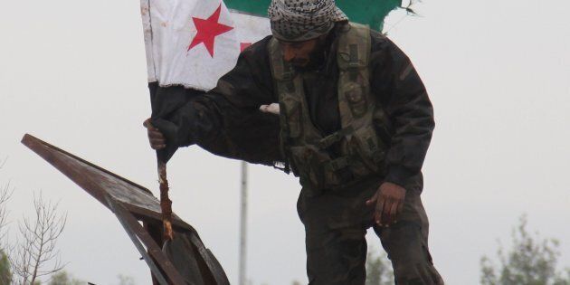 Convoys carried opposition fighters out of the last rebel pocket of Aleppo on Thursday.