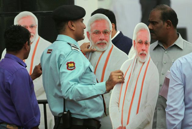 A private security guard stands holding cut-outs of Indian Prime Minister Narendra Modi, to be placed during a function to release Bharatiya Janata Party or BJP's manifesto for the upcoming general elections in New Delhi, India, Monday, April 8, 2019. India's general elections are scheduled to be held in seven phases starting from April 11. Votes will be counted on May 23. (AP Photo/Manish Swarup)