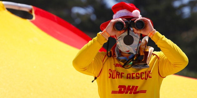 A surf lifesaver looks through binoculars while wearing a Christmas hat on Christmas Day at Sydney's Bondi Beach in Australia, December 25, 2016. REUTERS/David Gray