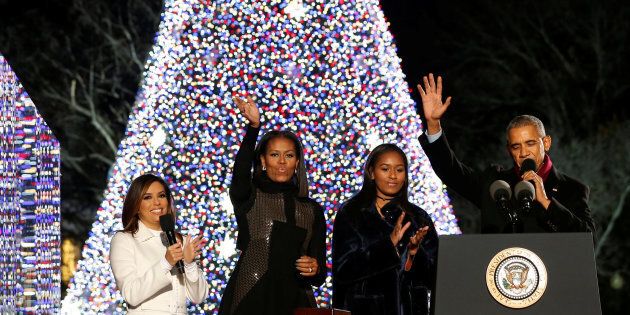 U.S. President Barack Obama (R), joined by first lady Michelle Obama (2nd L), their daughter Sasha (2nd R) and emcee Eva Longoria (L), reacts after pressing a button to light the National Christmas Tree in Washington, U.S. December 1, 2016. REUTERS/Jonathan Ernst