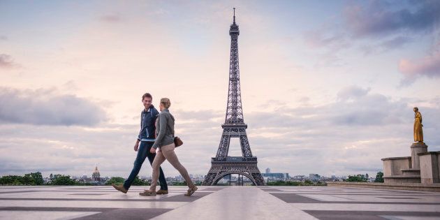 Caucasian couple walking near Eiffel Tower, Paris, France