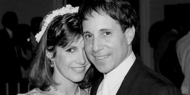 Carrie Fisher and Paul Simon pose together in 1983.