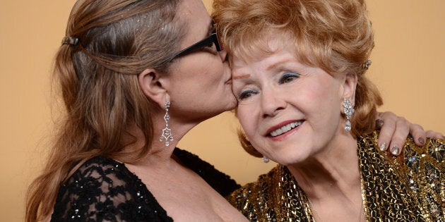 Debbie Reynolds and Carrie Fisher pose in the press room at the 21st Annual Screen Actors Guild Awards at The Shrine Auditorium on January 25, 2015 in Los Angeles, California.