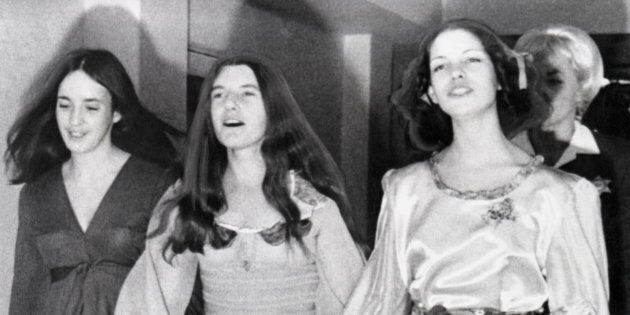 A trio of suspects in the Sharon Tate murder case sing as they march to court for a hearing. Left to right: Susan Atkins, Patricia Krenwinkel and Leslie Van Houten march abreast along a corridor toward the courtroom where Judge William Keene set April 20th as the date for their tiral with fellow suspect, Charles Manson.