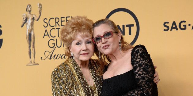Debbie Reynolds and Carrie Fisher pose in the press room at the 21st Annual Screen Actors Guild Awards at The Shrine Auditorium on January 25, 2015 in Los Angeles, California.