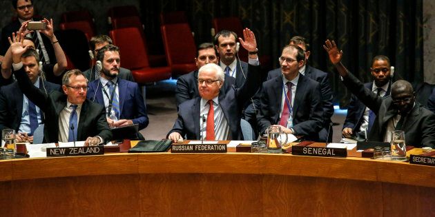 Russian Ambassador to the UN Vitaly Churkin (C) votes at the Security Council on a Russian-Turkish peace plan for Syria, on Dec. 31 at UN Headquarters in New York.