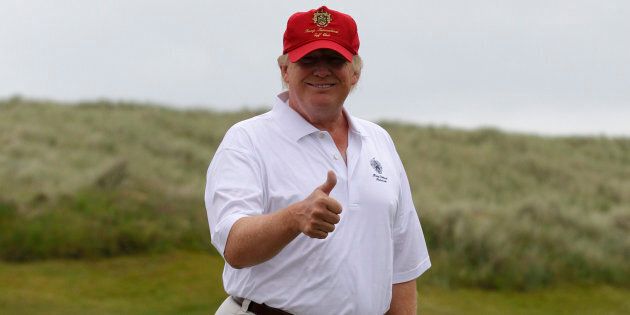 Real Estate magnate Donald Trump gestures as he plays golf during the opening of his Trump International Golf Links golf course near Aberdeen, northeast Scotland July 10, 2012. REUTERS/David Moir (BRITAIN - Tags: BUSINESS SPORT GOLF REAL ESTATE)