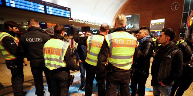 Police officers of Germany's federal police Bundespolizei check young men at the main railways station following New Year celebrations in Cologne, Germany, January 1, 2017.