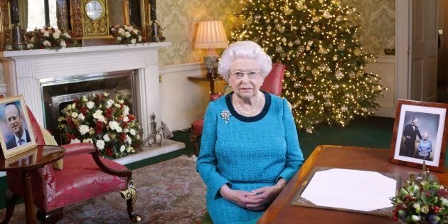 Britain's Queen Elizabeth II sits at a desk in the Regency Room in Buckingham Palace in London, after recording her Christmas Day broadcast to the Commonwealth which is to be broadcast on December 25, 2016. / AFP / POOL / Yui Mok (Photo credit should read YUI MOK/AFP/Getty Images)