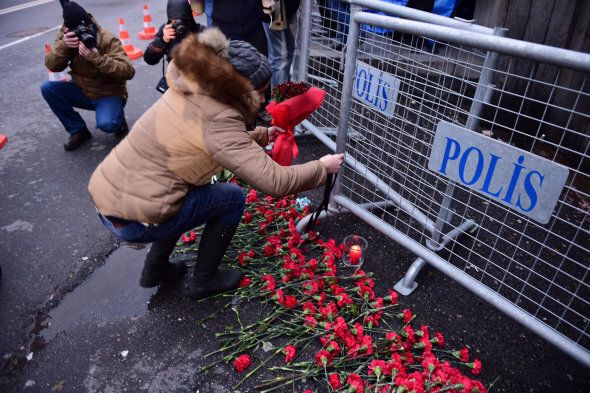 People lay flowers in front of the Reina night club following the massacre on New Year's Eve.