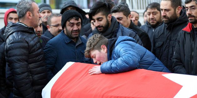 Family members and friends mourn as they attend funeral prayers for Ayhan Akin, one of the nightclub victims, in Istanbul, Sunday, Jan. 1, 2017. An assailant believed to have been dressed in a Santa Claus costume and armed with a long-barrelled weapon, opened fire at a nightclub in Istanbul's Ortakoy district during New Year's celebrations, killing dozens of people and wounding dozens of others in what the province's governor described as a terror attack. (AP Photo)