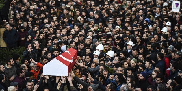 People carry the coffin of Yunus Gormek, 23, one of the victims of the Reina night club attack, during his funeral ceremony on Jan. 2, 2017, in Istanbul.