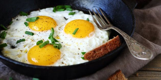 Hot fried eggs in a pan, close up
