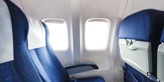 blue seats in economy class passenger section of airplane