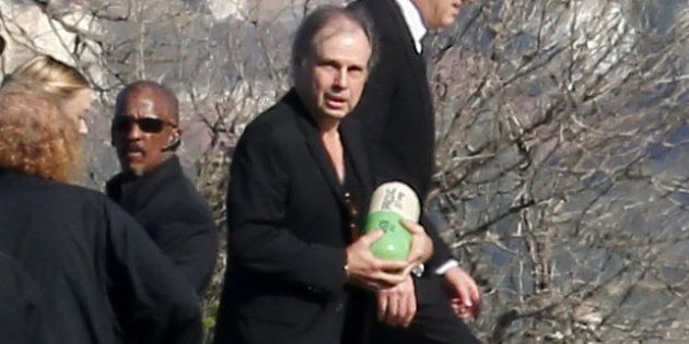 Carrie Fishers brother Todd carries her ashes at Forest Lawn Memorial Park