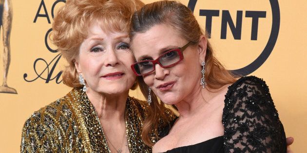 LOS ANGELES, CA - JANUARY 25: Honoree Debbie Reynolds (L) and actress Carrie Fisher pose in the press room at the 21st Annual Screen Actors Guild Awards at The Shrine Auditorium on January 25, 2015 in Los Angeles, California. (Photo by Steve Granitz/WireImage)
