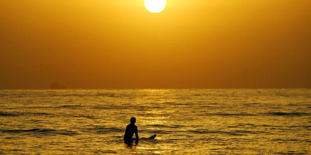 A surfer enjoys a cool surf at sunrise at Sydney's Manly Beach.