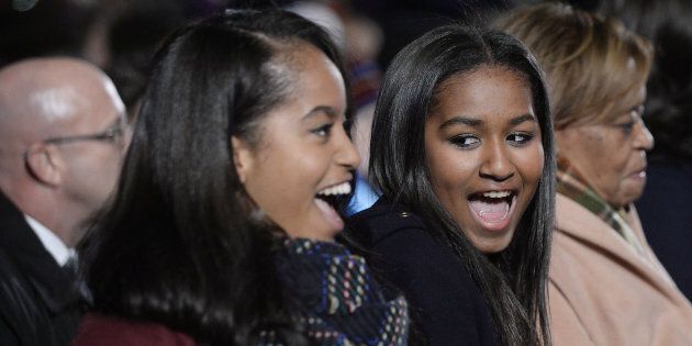 Daughters Malia, left, and Sasha Obama smile during the National Christmas Tree lighting ceremony on the Ellipse near the White House in Washington, D.C., U.S., on Thursday, Dec. 3, 2015. In 1923 President Calvin Coolidge lit the first National Christmas Tree, a 48-foot balsam fir tree decorated with 2,500 electric bulbs in red, white and green. Photographer: Olivier Douliery/Bloomberg via Getty Images