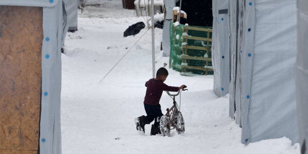 Hundreds of refugees face the extreme low temperatures in northern Greece in camps in or around Thessaloniki city on 11 January 2017. In Softex camp the temperature was -8°C with real feeling sense below -13°C and there was about 20cm of snowfall during a half day heaby snowstorm. The tents were snow covered. There is no running water as the pipes froze and many tents don't have electricity and heating. Also many refugees without document have been forced to leave the camp. (Photo by Nicolas Economou/NurPhoto via Getty Images)