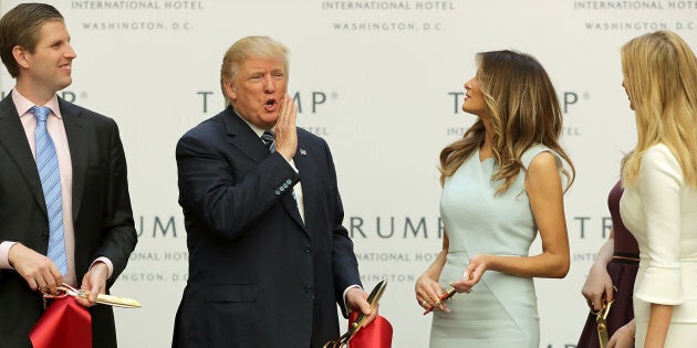 WASHINGTON, DC - OCTOBER 26: Republican presidential nominee Donald Trump celebrates with his son Eric Trump (L), wife Melania Trump and daughter Tiffany Trump (R) after cutting the ribbon at the new Trump International Hotel October 26, 2016 in Washington, DC. The hotel, built inside the historic Old Post Office, has 263 luxry rooms, including the 6,300-square-foot 'Trump Townhouse' at $100,000 a night, with a five-night minimum. The Trump Organization was granted a 60-year lease to the historic building by the federal government before the billionaire New York real estate mogul announced his intent to run for president. (Photo by Chip Somodevilla/Getty Images)