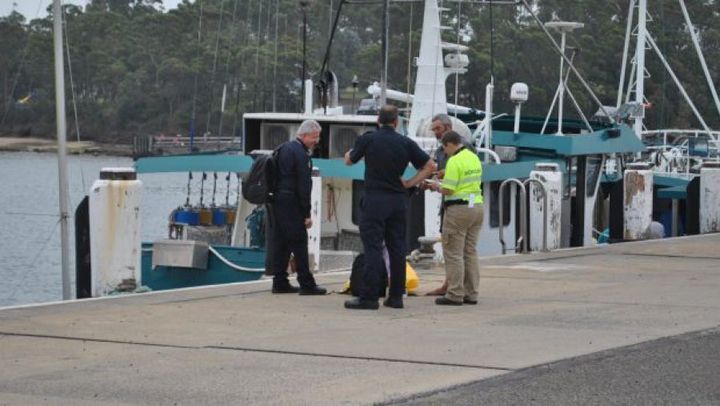 Alan Langdon speaks with Australian Border Force officials at Ulladulla Harbour