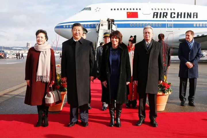 Chinese President Xi Jinping and his wife Peng Liyuan with Swiss President Doris Leuthard and her husband Roland Hausin listen to the national anthems during a welcome ceremony upon their arrival for a state visit to Switzerland on January 15, 2017 at Zurich Airport.