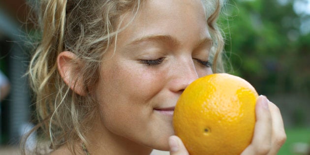 Woman smelling fresh orange