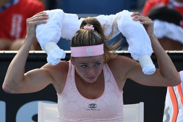 Italy's Camila Giorgi faces the heat as she prepares to go back to play against Switzerland's Timea Bacsinszky during their women's singles match.