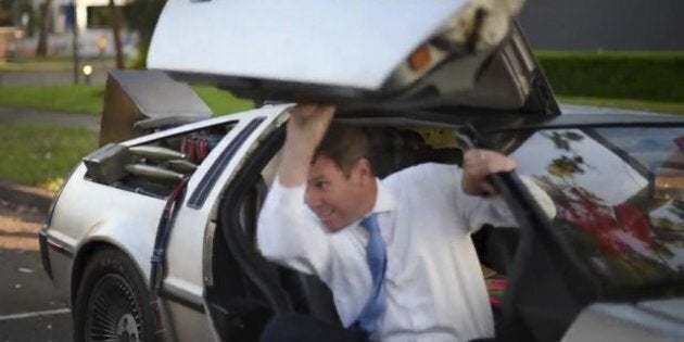 Mike Baird hops out of a Delorean on 'Back To The Future Day'