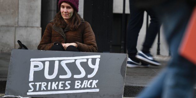 A protester sits with a placard at the end of the Women's March in London on January 21, 2017 as part of a global day of protests against new US President Donald Trump.Thousands of people marched through central London on January 21 as part of a global day of protests against new US President Donald Trump and his derogatory remarks about women. The largely female crowd, which also had many men and children, marched from the US embassy to Trafalgar Square, chanting 'dump Trump' and waving banners demanding equal rights. / AFP / Ben STANSALL (Photo credit should read BEN STANSALL/AFP/Getty Images)