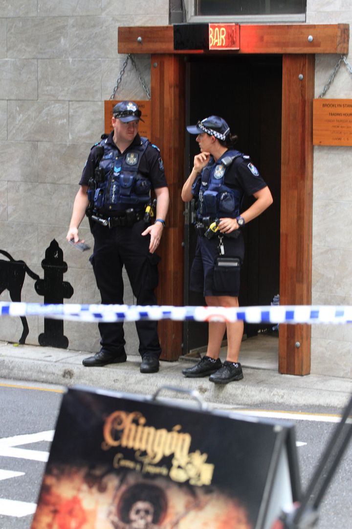 Police stand near the scene of a fatal shooting on a Brisbane film set