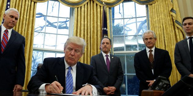 POTUS Donald Trump joined by men, signs an order to reinstate Reagan’s ‘Global Gag Rule' which bars international health organisations that receive U.S. funding from mentioning abortion as a family planning option. REUTERS/Kevin Lamarque