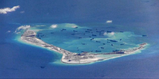 FILE PHOTO: Chinese dredging vessels are purportedly seen in the waters around Mischief Reef in the disputed Spratly Islands in the South China Sea in this still image from video taken by a P-8A Poseidon surveillance aircraft provided by the United States Navy May 21, 2015. U.S. Navy/Handout via Reuters/File Photo ATTENTION EDITORS - THIS IMAGE WAS PROVIDED BY A THIRD PARTY. EDITORIAL USE ONLY. THIS PICTURE WAS PROCESSED BY REUTERS TO ENHANCE QUALITY. AN UNPROCESSED VERSION IS AVAILABLE IN OUR ARCHIVE.