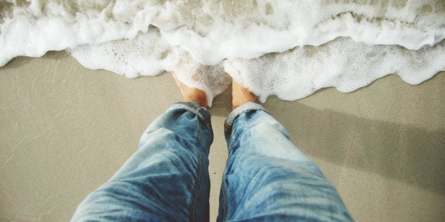 Standing on beach, sea surf.