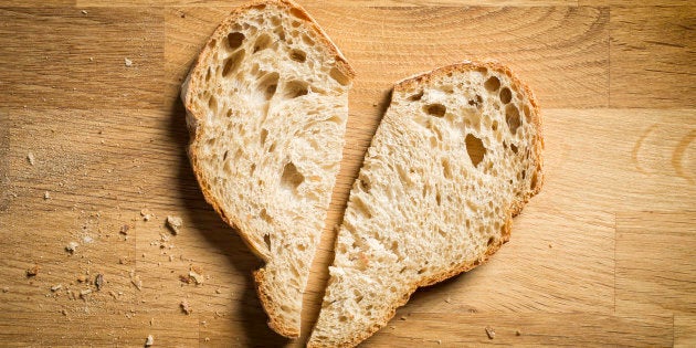 two slices of bread arranged in a heart shape on chopping block