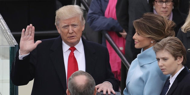 WASHINGTON, DC - JANUARY 20: Supreme Court Justice John Roberts (2L) administers the oath of office to U.S. President Donald Trump (L) as his wife Melania Trump holds the Bible and son Barron Trump looks on, on the West Front of the U.S. Capitol on January 20, 2017 in Washington, DC. In today's inauguration ceremony Donald J. Trump becomes the 45th president of the United States. (Photo by Drew Angerer/Getty Images)