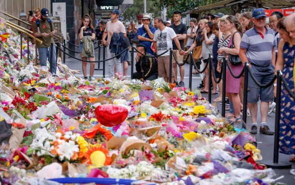 People pay their respects at a a tribute in Bourke St Mall