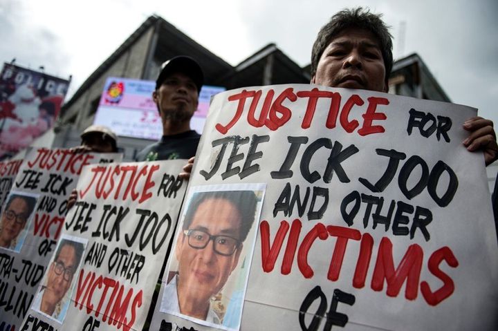 Activists hold a protest at the spot where Jee Ick Joo was killed.