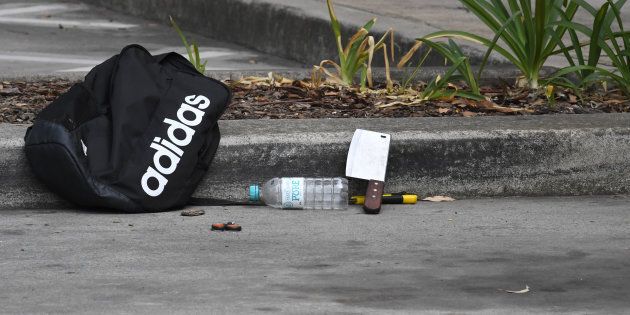 A large cleaver and a box cutter can be seen at the site where police arrested a 16-year-old boy near Bonnyrigg High School.