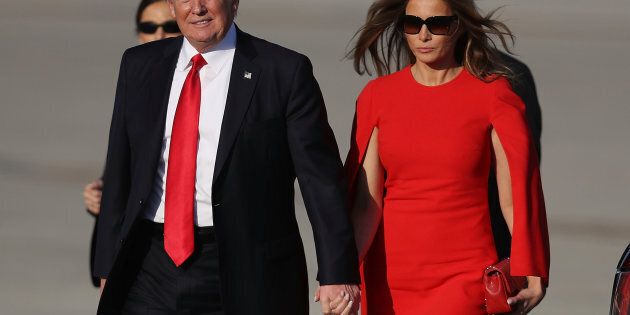PALM BEACH, FL - FEBRUARY 03: U.S. President Donald Trump walks with his wife Melania Trump on the tarmac after he arrived on Air Force One at the Palm Beach International Airport for a visit to his Mar-a-Lago Resort for the weekend on February 3, 2017 in Palm Beach, Florida. President Donald Trump is on his his first visit to Palm Beach since his inauguration. (Photo by Joe Raedle/Getty Images)