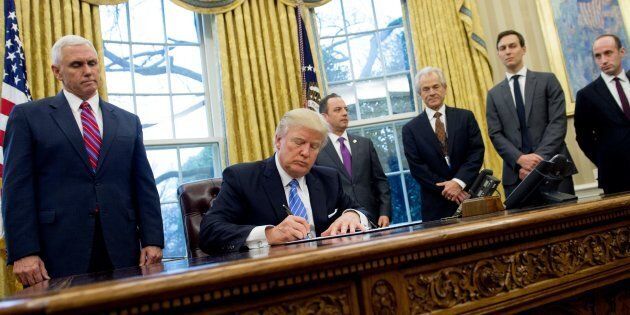 This photo of Donald Trump signing an executive order to limit abortion rights access flanked by a group of men went viral
