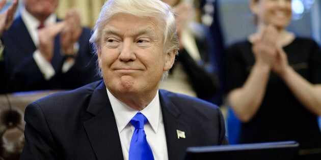 U.S. President Donald Trump smiles after signing executive orders related to a lobbying ban in the Oval Office of the White House in Washington, D.C., U.S., on Saturday, Jan. 28, 2017. Trump moved to reorganize his National Security Council, implement a lobbying ban for political appointees once they exit his administration, and order the Pentagon to create a plan to defeat the Islamic State terror organization. Photographer: Pete Marovich/Pool via Bloomberg