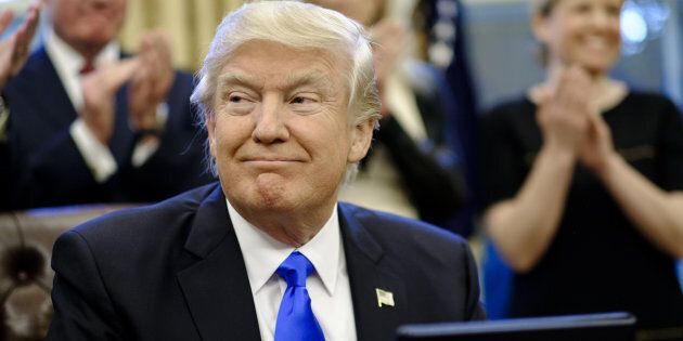 U.S. President Donald Trump smiles after signing executive orders related to a lobbying ban in the Oval Office of the White House in Washington, D.C., U.S., on Saturday, Jan. 28, 2017. Trump moved to reorganize his National Security Council, implement a lobbying ban for political appointees once they exit his administration, and order the Pentagon to create a plan to defeat the Islamic State terror organization. Photographer: Pete Marovich/Pool via Bloomberg