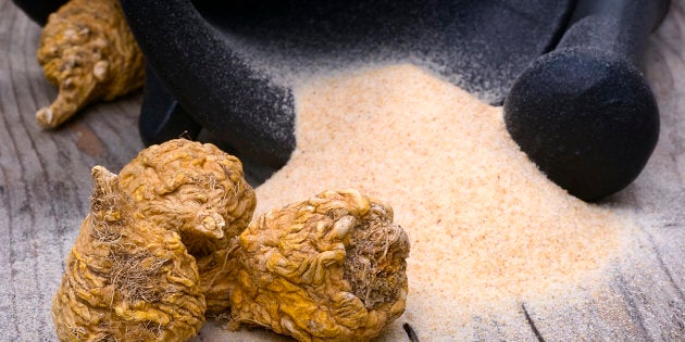 Peruvian ginseng or maca (Lepidium meyenii), dried root and powder on wooden table