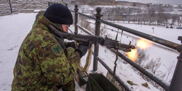 An Estonian paramilitary volunteer fires a machine gun yards from the border with Russia. Jan. 14.