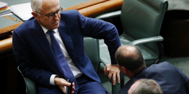 Prime Minister Malcolm Turnbull speaks with Minister for Environment and Energy Josh Frydenberg during Question Time.