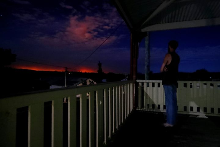 Evacuated resident Nathan Blatch from Uarby views the glow of the Sir Ivan fire east of Dunedoo, NSW, from the Black Stump Inn in Coolah, NSW, on Sunday 12 February 2017. fedpol Photo: Alex Ellinghausen