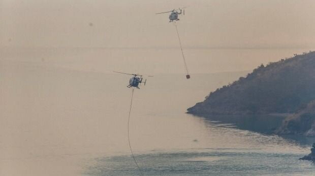 Helicopters fill buckets from Lyttelton Harbour