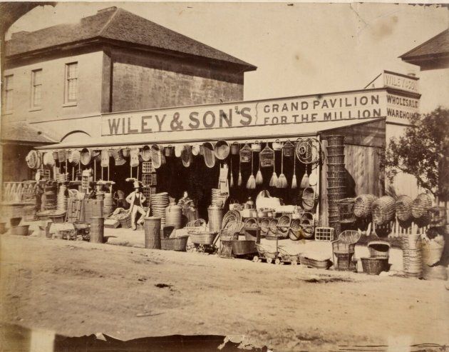 This photo is from 1858 and shows Wiley and Sons, on the corner of Pitt and Park Streets, Sydney. It was run by Hannah Wiley, a mother of four. She most likely ran the business with her husband David as he is also mentioned in the advertising.